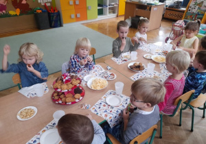 Dzieci częstują się przy urodzinowym stole